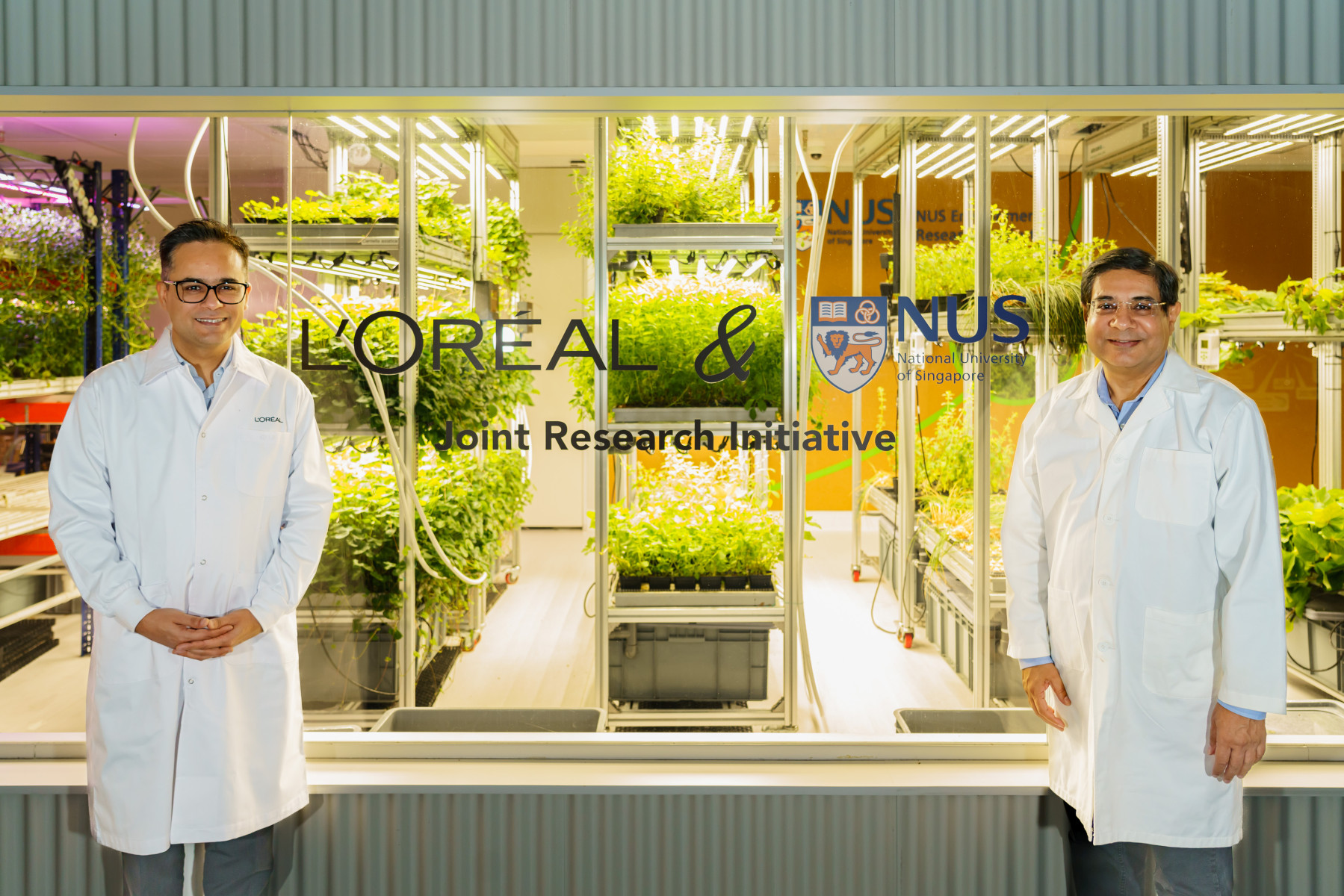 Assoc Prof Sanjay Swarup (right), Director of NUS Environmental Research Institute, and Dr Tarun Chopra (left), Director of Advanced Research, L’Oréal Singapore Research & Innovation, at the new grow zone in NUS Agritech Centre where scientists will study the use of beneficial soil microbes to increase the yields of commercially important crops in a climate-controlled environment. (Photo: L’Oréal Singapore)