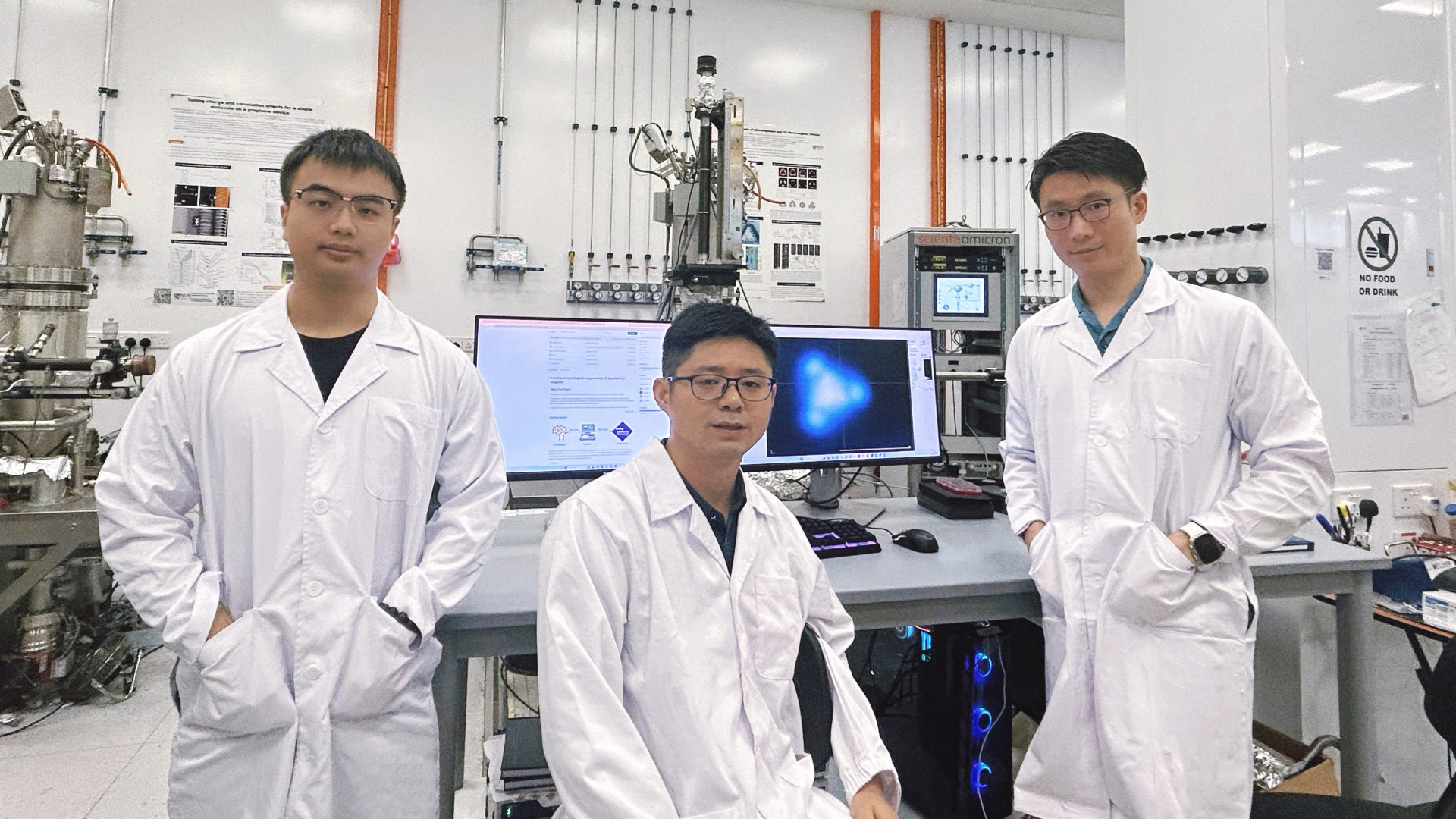 Assoc Prof Lu Jiong (centre), Dr Su Jie (right), and Dr Li Jiali (left) from the NUS Department of Chemistry developed the concept of an atomic robotic probe that mimics the decision-making process of chemists which enables the fabrication of quantum materials with greater control.